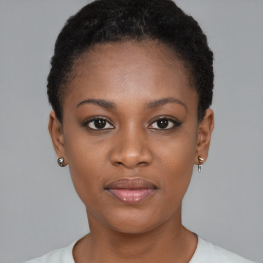 Joyful black young-adult female with short  brown hair and brown eyes