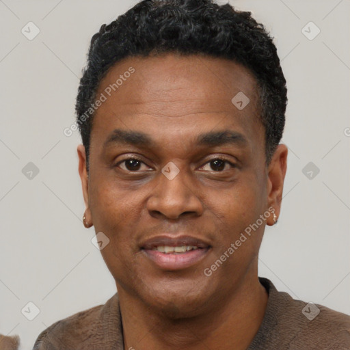 Joyful black young-adult male with short  black hair and brown eyes