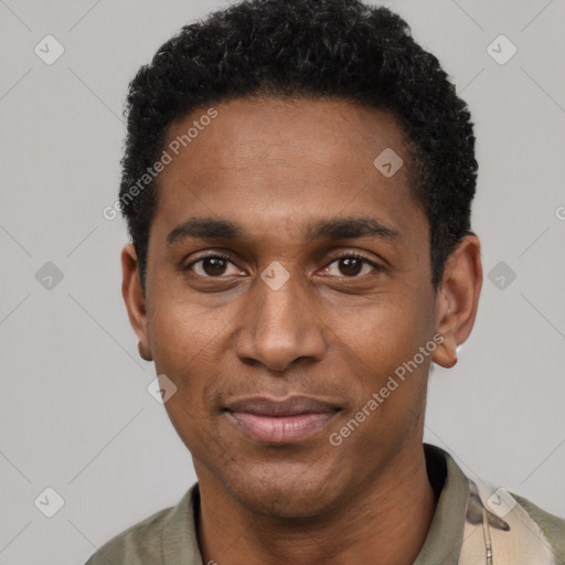 Joyful black adult male with short  black hair and brown eyes