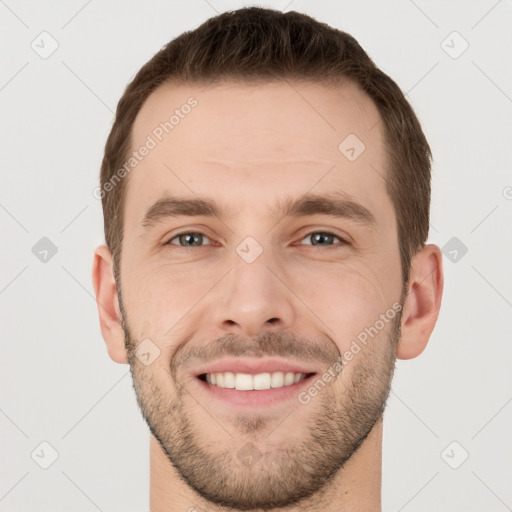 Joyful white young-adult male with short  brown hair and grey eyes