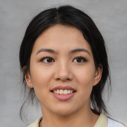 Joyful asian young-adult female with medium  black hair and brown eyes