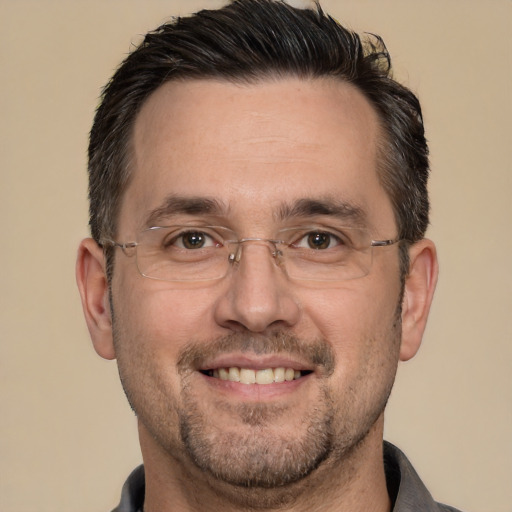 Joyful white adult male with short  brown hair and brown eyes