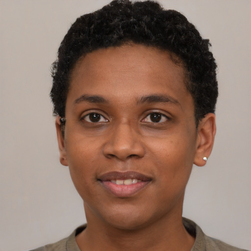 Joyful black young-adult female with short  black hair and brown eyes