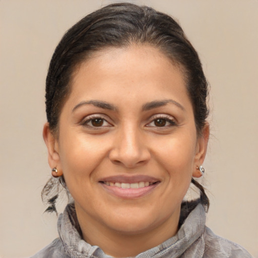Joyful latino young-adult female with short  brown hair and brown eyes