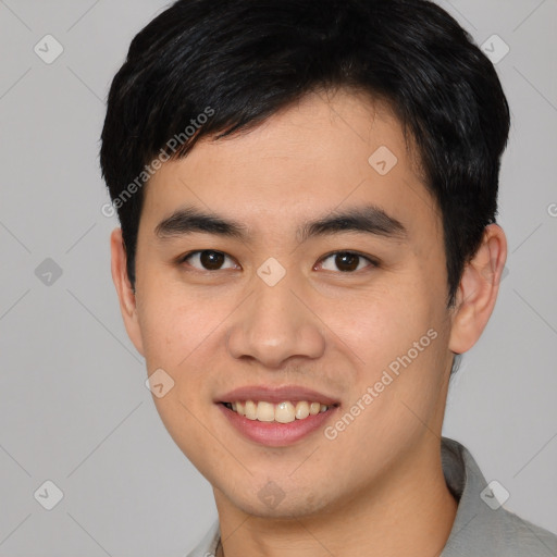 Joyful asian young-adult male with short  black hair and brown eyes