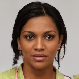 Joyful black young-adult female with medium  brown hair and brown eyes