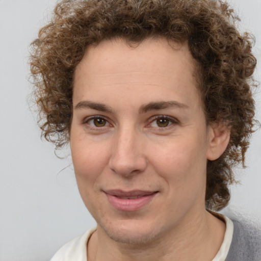 Joyful white adult female with short  brown hair and brown eyes