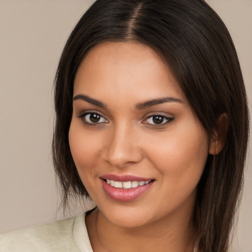 Joyful white young-adult female with long  brown hair and brown eyes