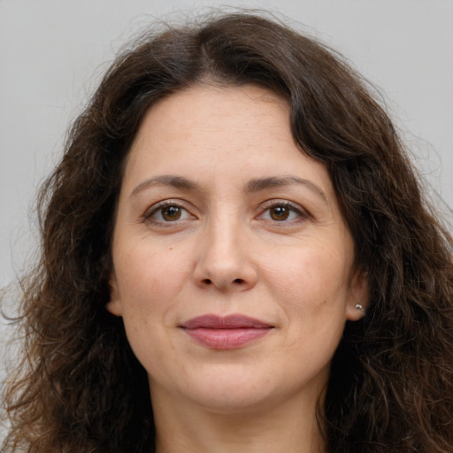 Joyful white adult female with long  brown hair and brown eyes