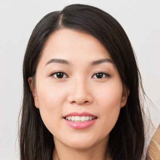 Joyful asian young-adult female with long  brown hair and brown eyes