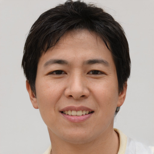 Joyful asian young-adult female with short  brown hair and brown eyes