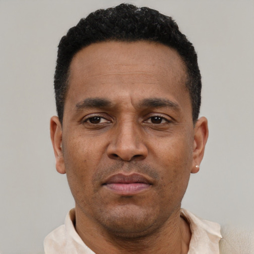 Neutral latino adult male with short  black hair and brown eyes