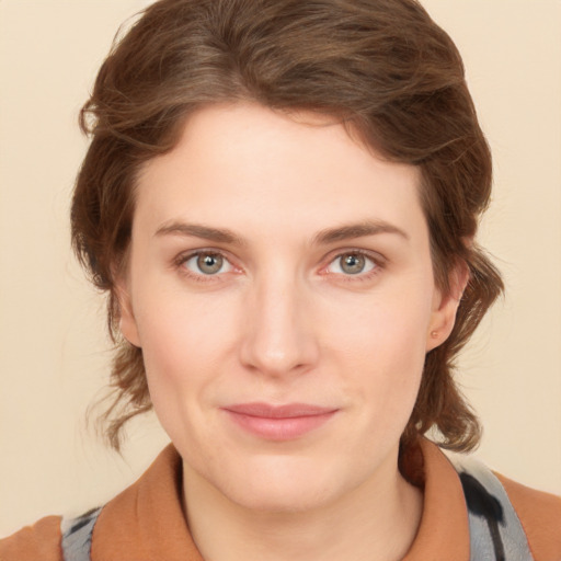 Joyful white young-adult female with medium  brown hair and blue eyes