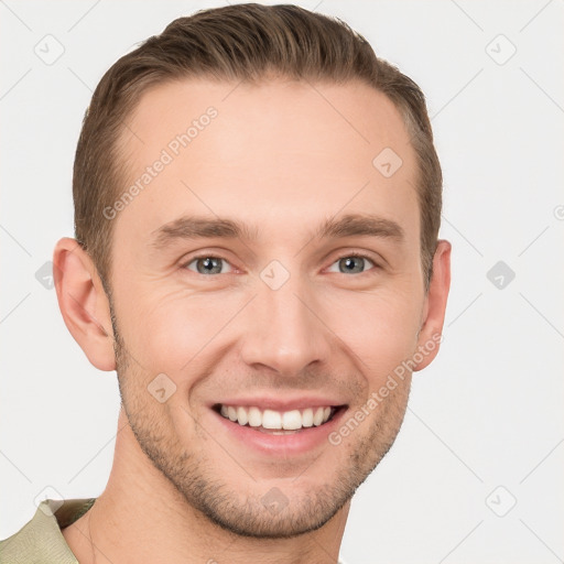 Joyful white young-adult male with short  brown hair and grey eyes