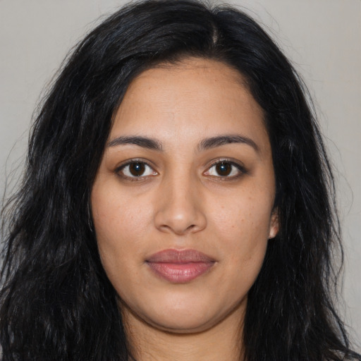 Joyful latino young-adult female with long  black hair and brown eyes
