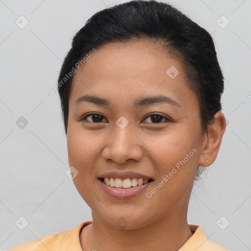 Joyful latino young-adult female with short  brown hair and brown eyes