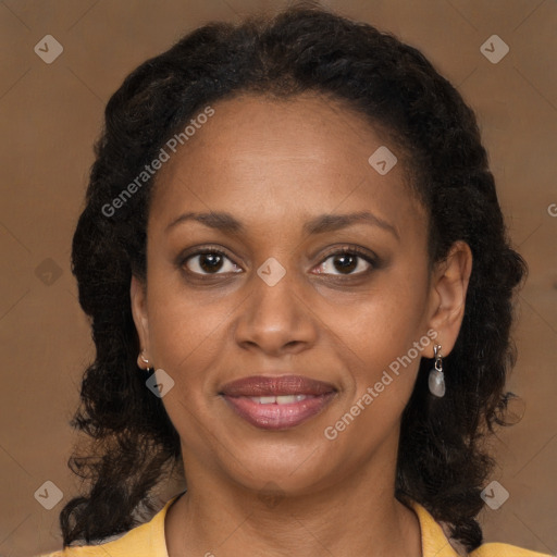 Joyful black adult female with medium  brown hair and brown eyes