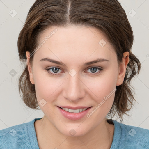 Joyful white young-adult female with medium  brown hair and blue eyes