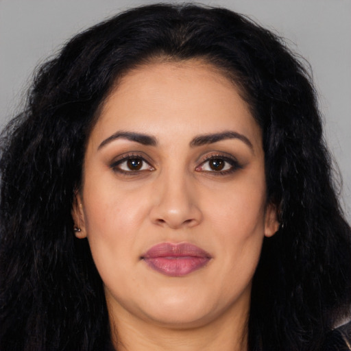 Joyful latino young-adult female with long  black hair and brown eyes