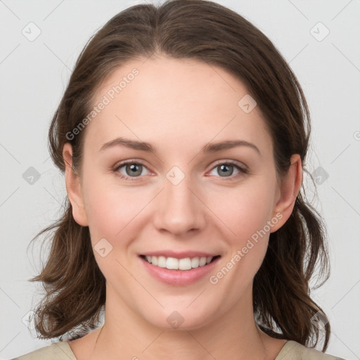 Joyful white young-adult female with medium  brown hair and grey eyes