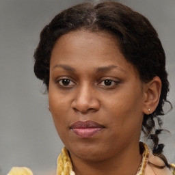 Joyful black adult female with medium  brown hair and brown eyes