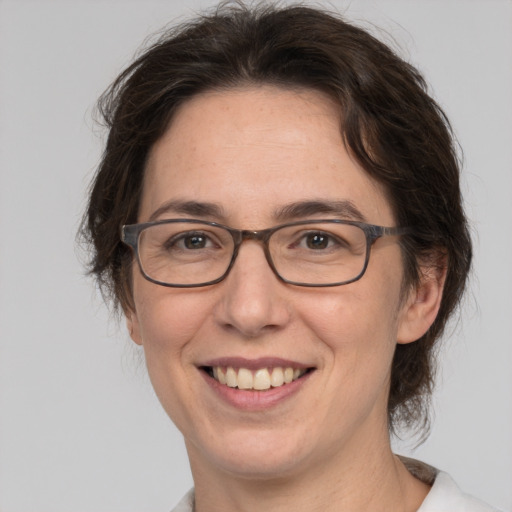 Joyful white adult female with medium  brown hair and brown eyes