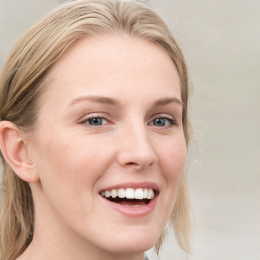 Joyful white young-adult female with medium  brown hair and blue eyes