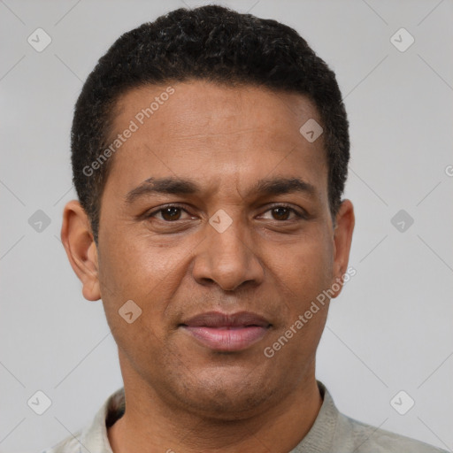 Joyful latino adult male with short  brown hair and brown eyes