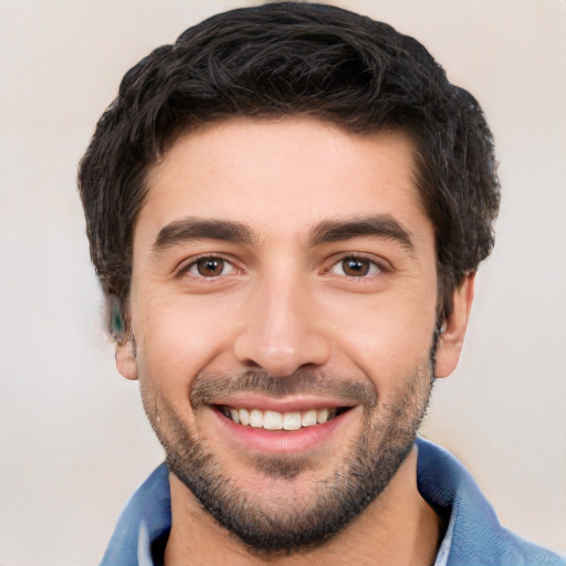 Joyful white young-adult male with short  black hair and brown eyes