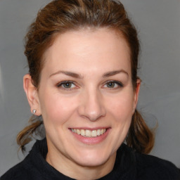 Joyful white young-adult female with medium  brown hair and brown eyes