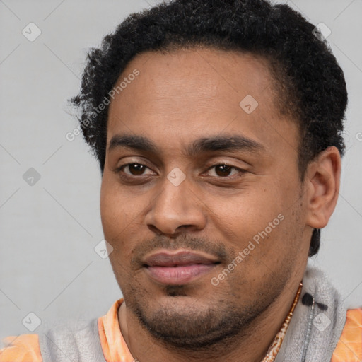 Joyful latino young-adult male with short  black hair and brown eyes