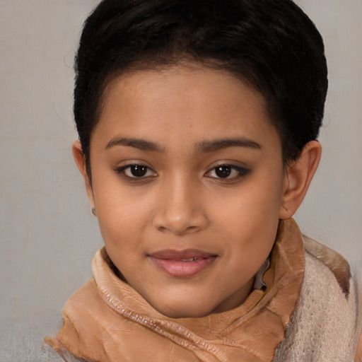 Joyful latino young-adult female with short  brown hair and brown eyes