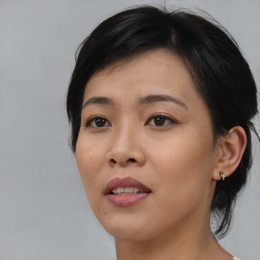 Joyful asian young-adult female with medium  black hair and brown eyes