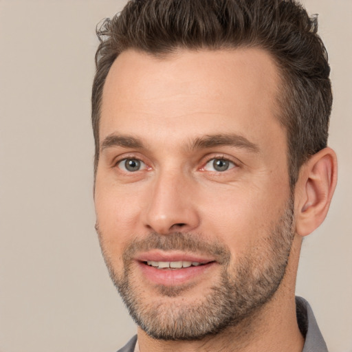 Joyful white adult male with short  brown hair and brown eyes