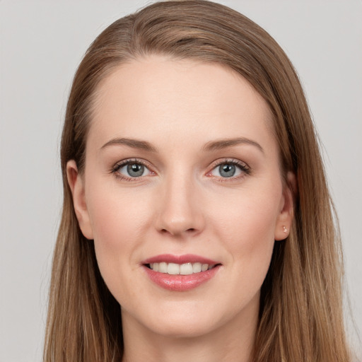 Joyful white young-adult female with long  brown hair and grey eyes