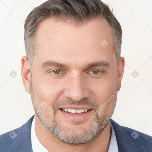 Joyful white adult male with short  brown hair and brown eyes