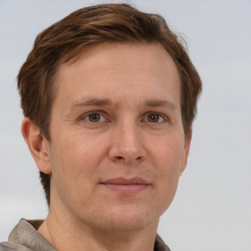 Joyful white adult male with short  brown hair and grey eyes