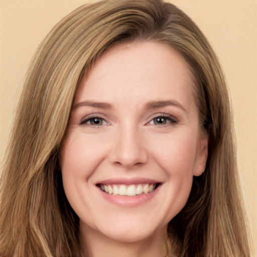 Joyful white young-adult female with long  brown hair and green eyes