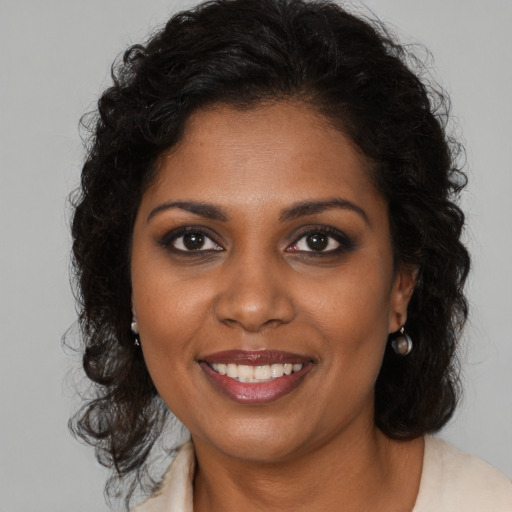 Joyful black young-adult female with medium  brown hair and brown eyes