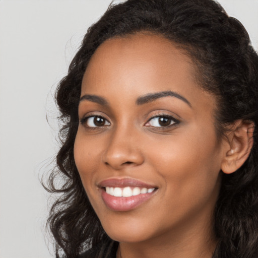 Joyful latino young-adult female with long  brown hair and brown eyes