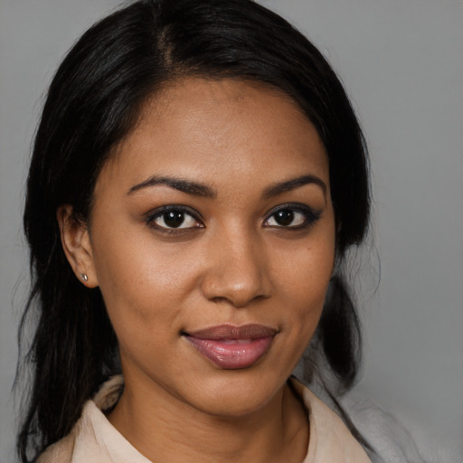 Joyful black young-adult female with medium  black hair and brown eyes