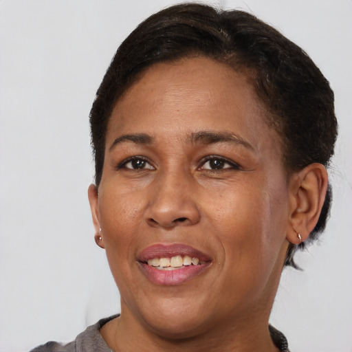 Joyful black adult female with short  brown hair and brown eyes