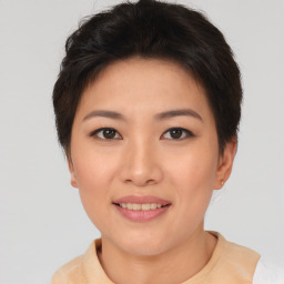 Joyful asian young-adult female with short  brown hair and brown eyes