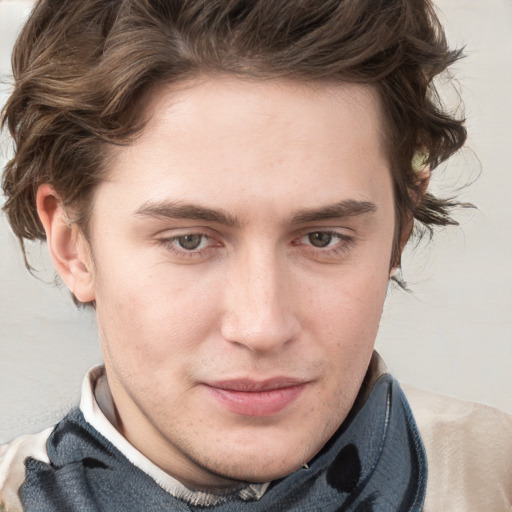 Joyful white young-adult male with short  brown hair and blue eyes