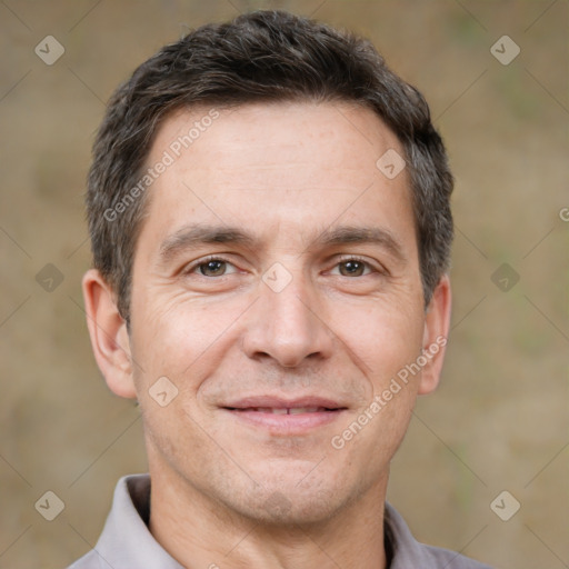 Joyful white adult male with short  brown hair and brown eyes