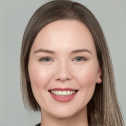 Joyful white young-adult female with long  brown hair and blue eyes