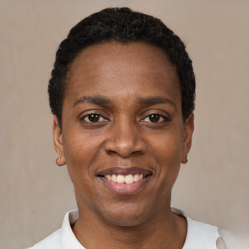 Joyful black young-adult female with short  black hair and brown eyes