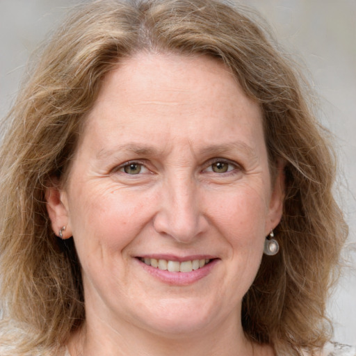 Joyful white adult female with medium  brown hair and grey eyes