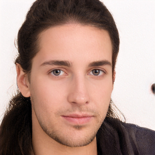 Neutral white young-adult male with long  brown hair and brown eyes