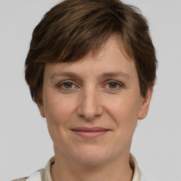 Joyful white adult female with short  brown hair and grey eyes